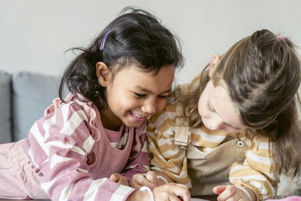 Cheerful diverse girls drawing picture together