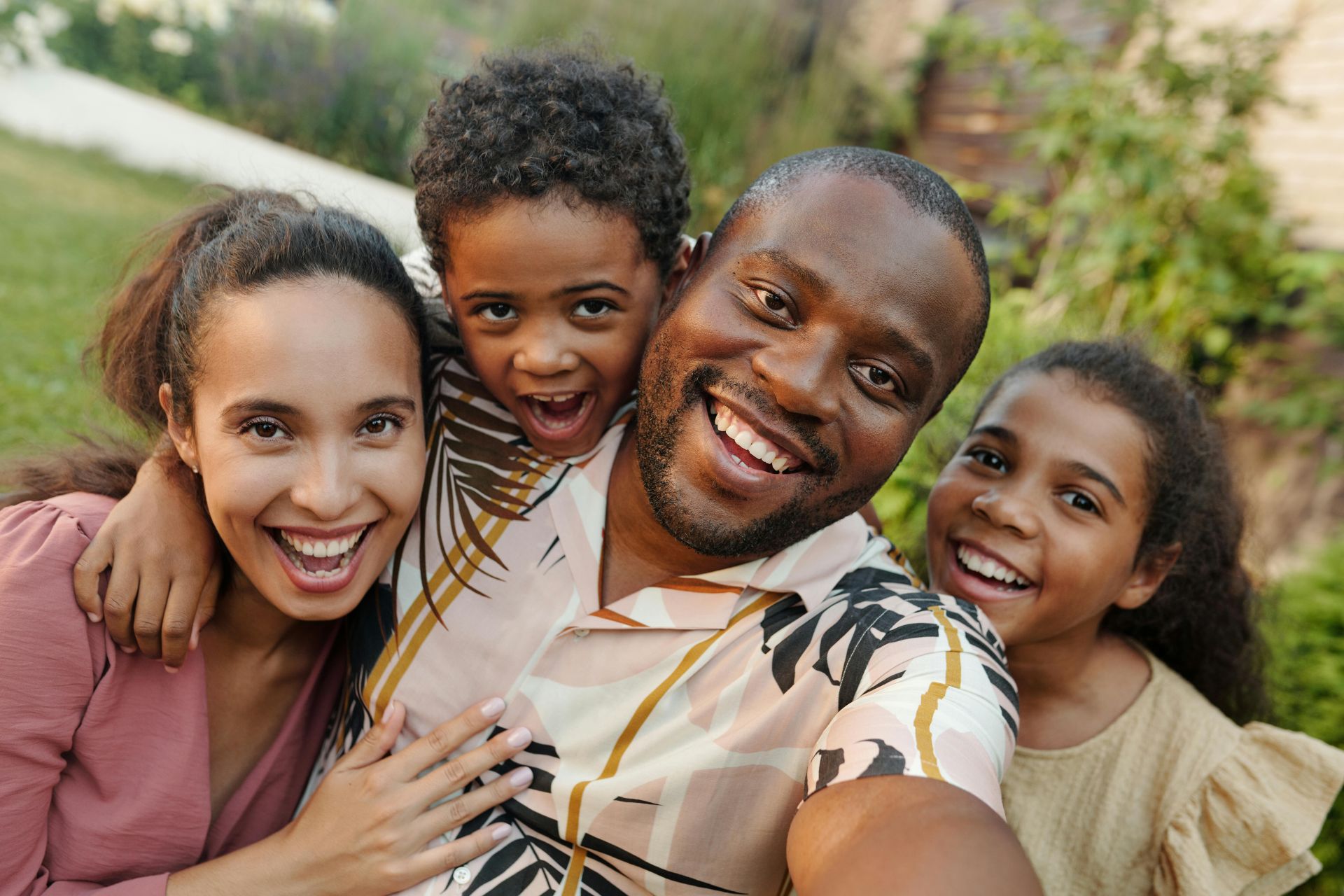 A Family Smiling for a Groupie Photo Shot